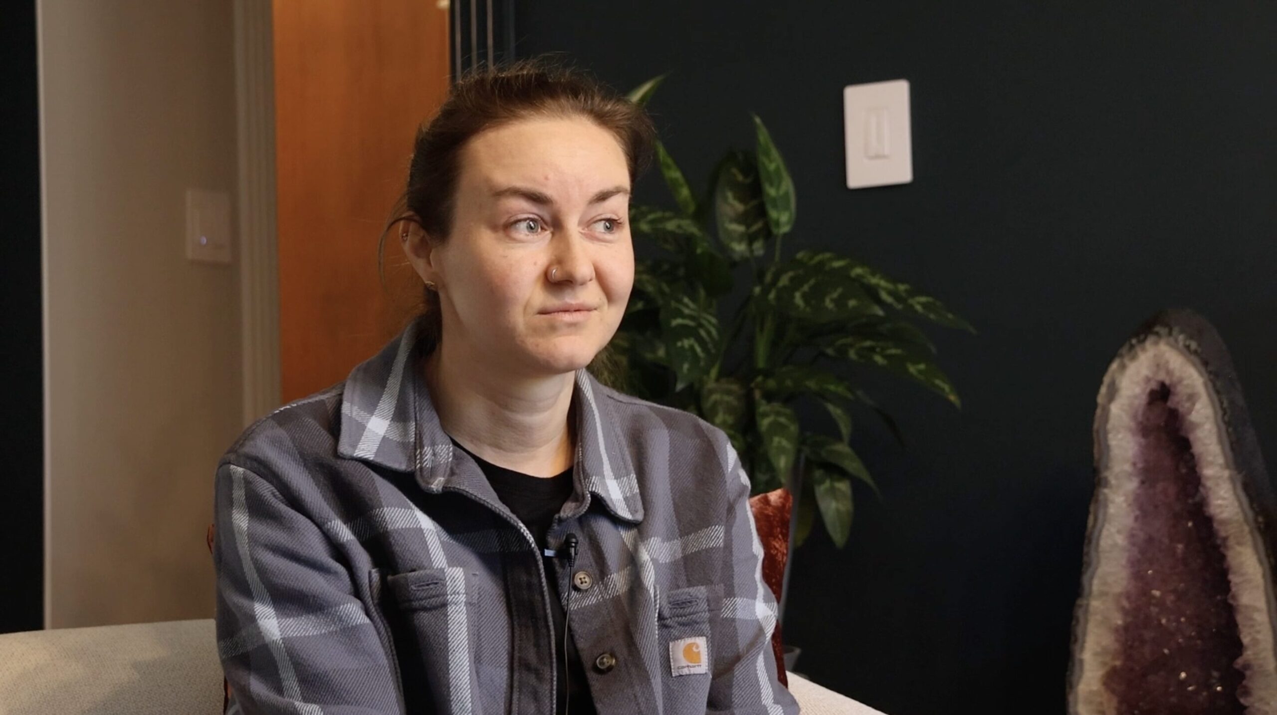 Alina Briedneiva, a 33-year-old Ukrainian refugee, sits in her brother's living room in Cary, North Carolina. She lived with him and his family for a year as she settled into her new life in America.