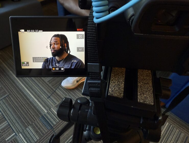 Image of U.S. bobsledder Manteo Mitchell as seen through a video recorder screen, during an interview where he discusses his training plans for the 2026 Winter Olympics.