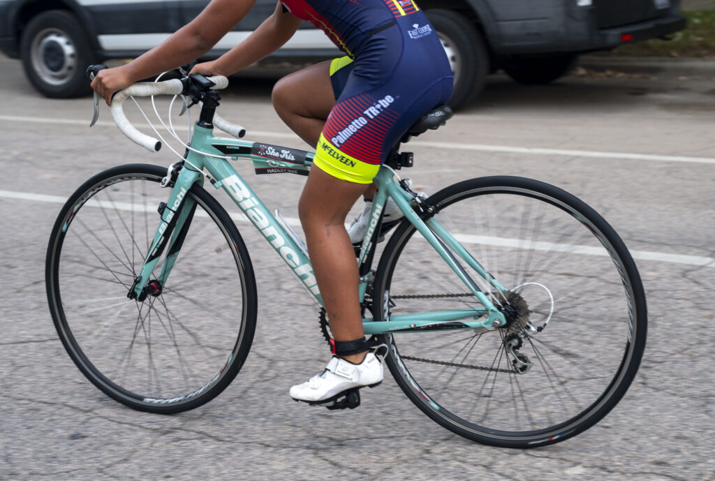 A participant rides down Old Chapel Hill Road as part of the biking portion of She Tris triathlon Sept. 14, 2025, in Chapel Hill. The event combines swimming, cycling and running, and challenges women of all levels of experience to test their endurance.