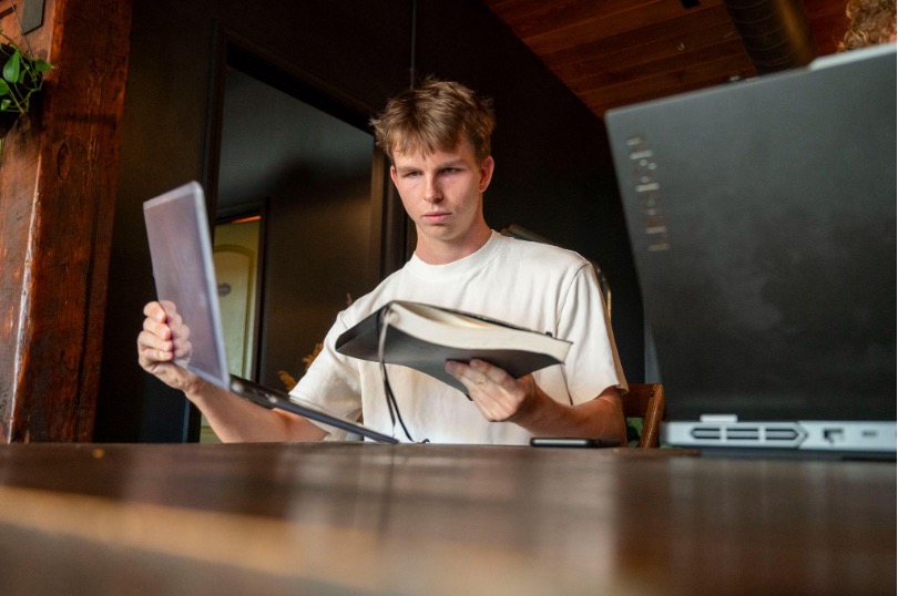Dennis Perumov, recent graduate of UNC-Chapel Hill and co-founder of Uniplanner, settles in
for a long day of work at his favorite coffee shop in Durham, North Carolina. Photo by Adair
Martin.