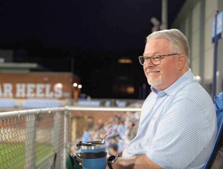 Randall Keen smiles as he watches UNC men's soccer