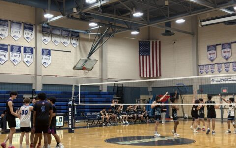 North Carolina School of Science and Mathematics boys volleyball team plays against Triangle Math and Science Academy boys volleyball team in a high school gym.